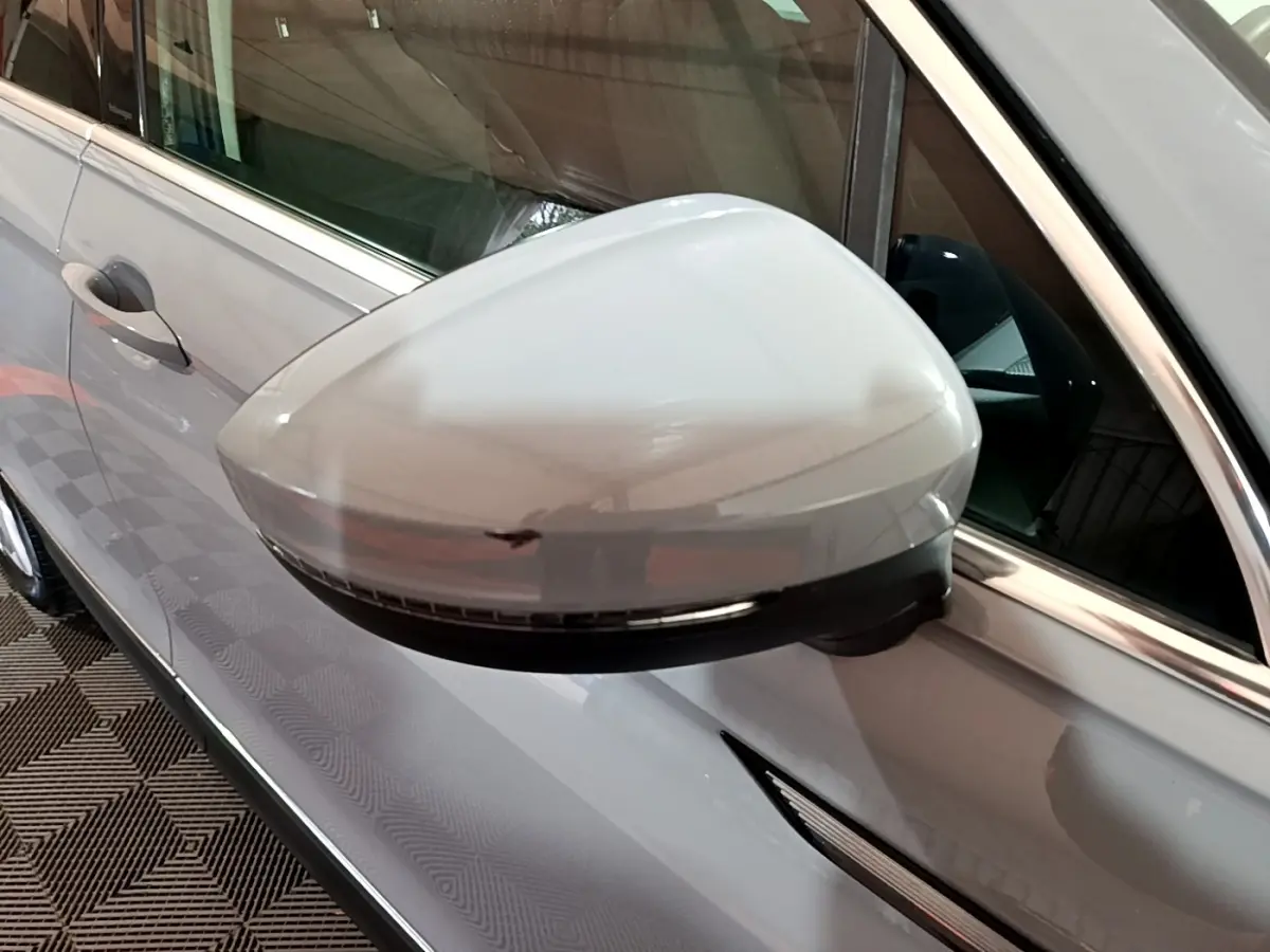 Gros plan sur le rétroviseur côté gauche gris clair du Volkswagen Tiguan 2.0 TDI 200 DSG7 Elegance 4Motion 2021.