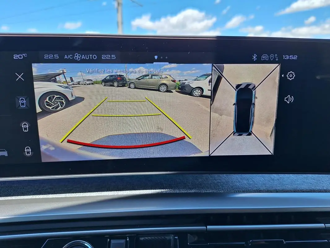 Écran de caméra de recul du Peugeot 3008 gris foncé montrant l’arrière et vue aérienne du véhicule en stationnement.