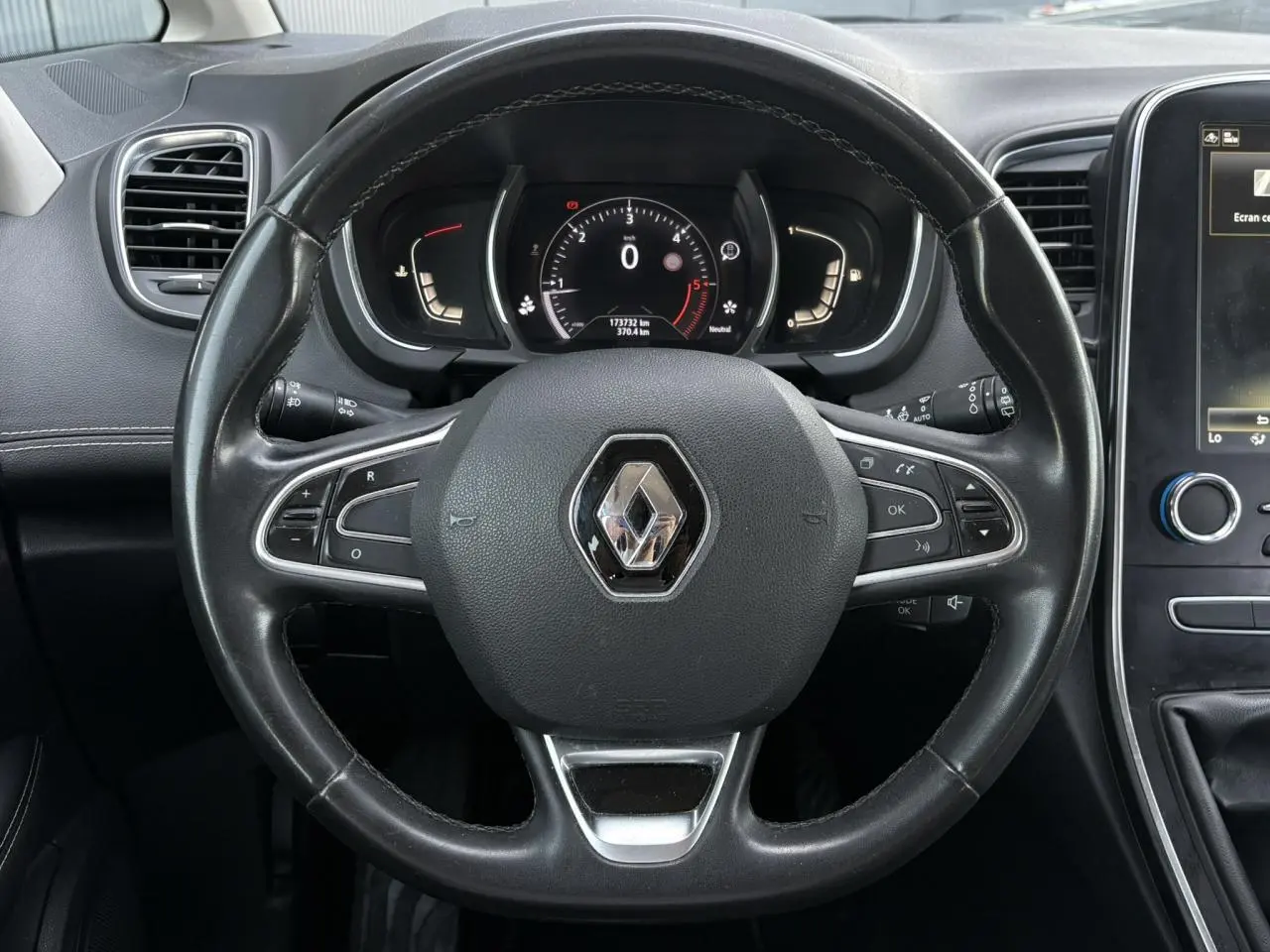 Vue frontale du volant cuir noir avec logo Renault au centre et tableau de bord numérique du Grand Scenic IV 2021.