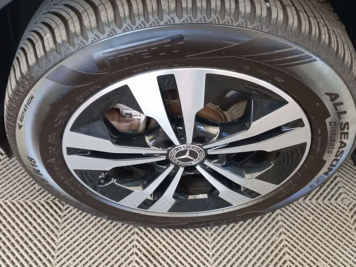 Gros plan sur la jante alliage bicolore et pneu Pirelli All Season du Mercedes GLA gris foncé.