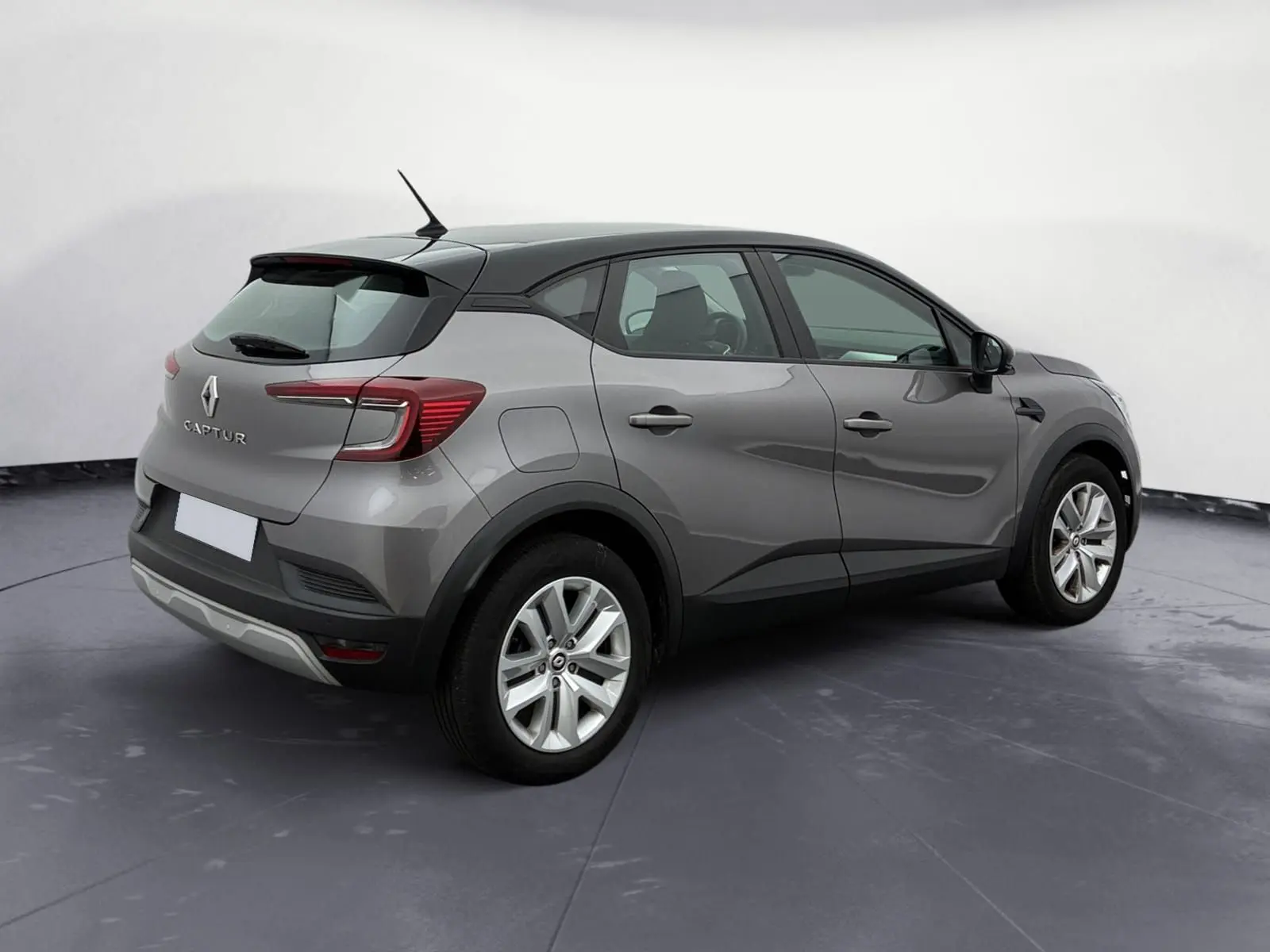 Renault Captur TCE 140 Business gris cassiopée avec toit noir, vue 3/4 arrière côté droit, roue de secours visible.