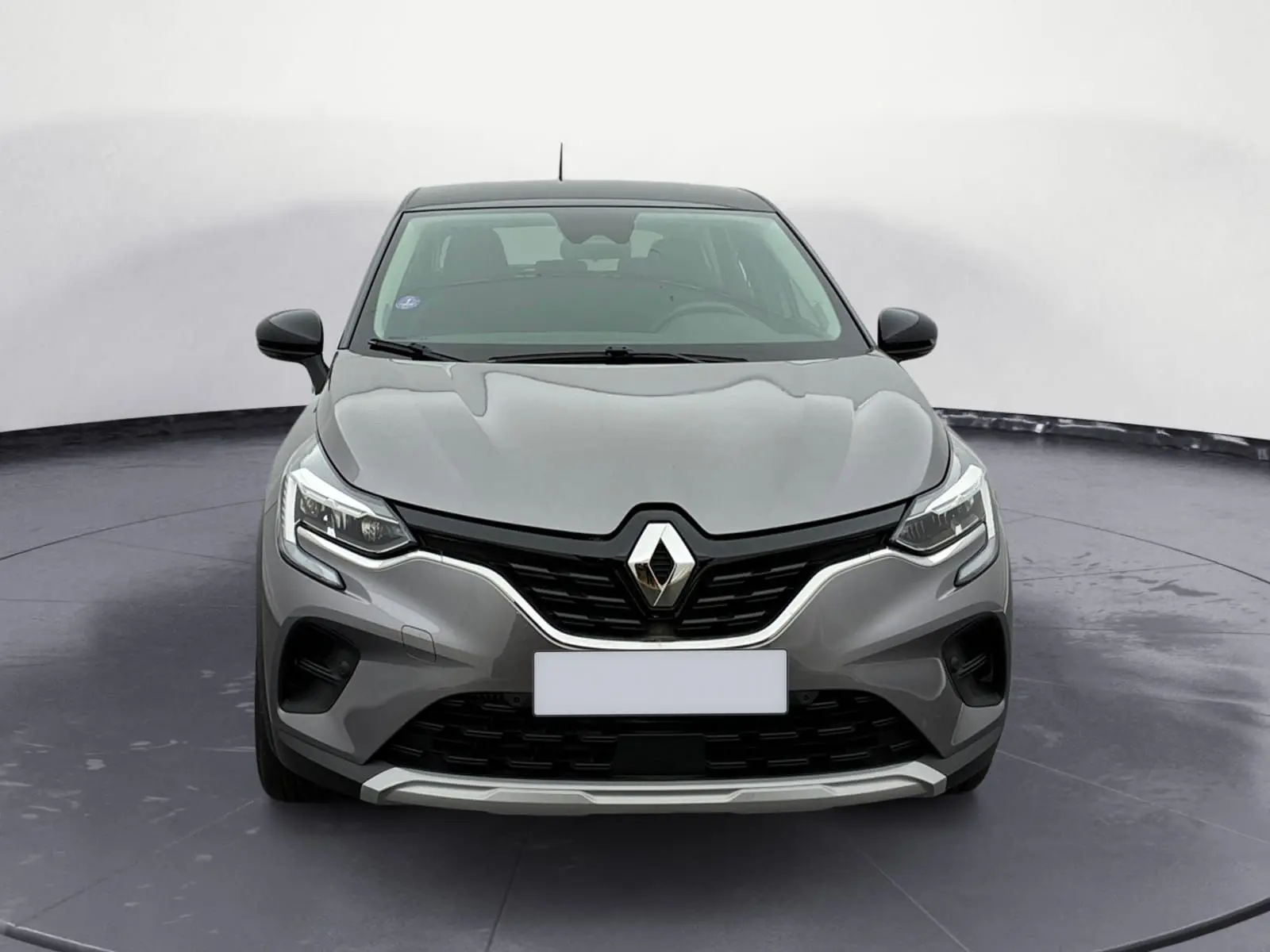 Vue avant d'un Renault Captur gris Cassiopée avec toit noir, calandre noire et signature lumineuse LED en C.