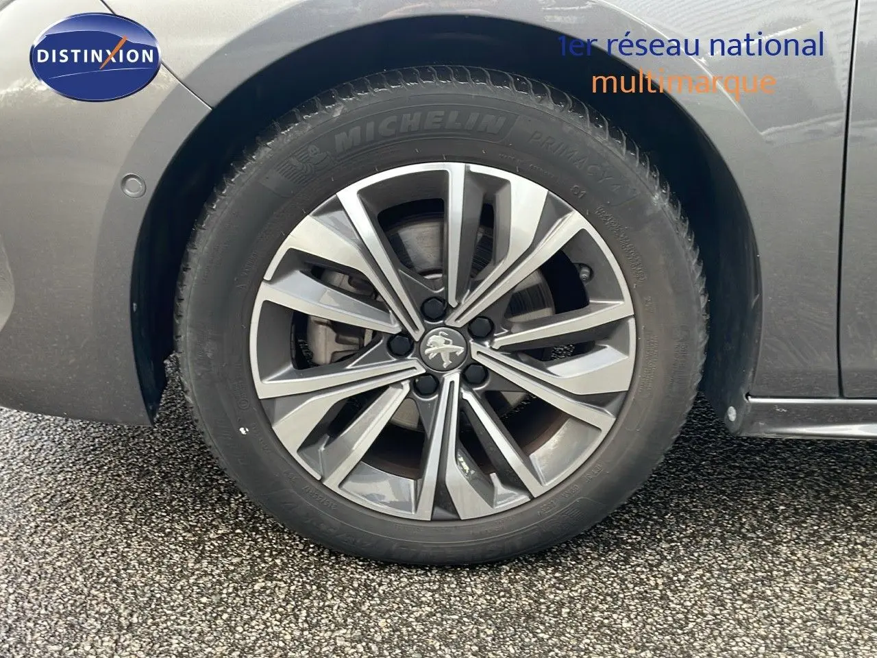Gros plan sur la roue avant gauche de la Peugeot 508 gris platinium métal, mettant en valeur la jante alliage à design moderne.