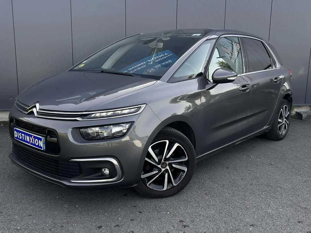 Vue 3/4 avant droit d'une Citroën C4 Spacetourer gris Platinium avec jantes alliage bi-ton et feux LED distinctifs.