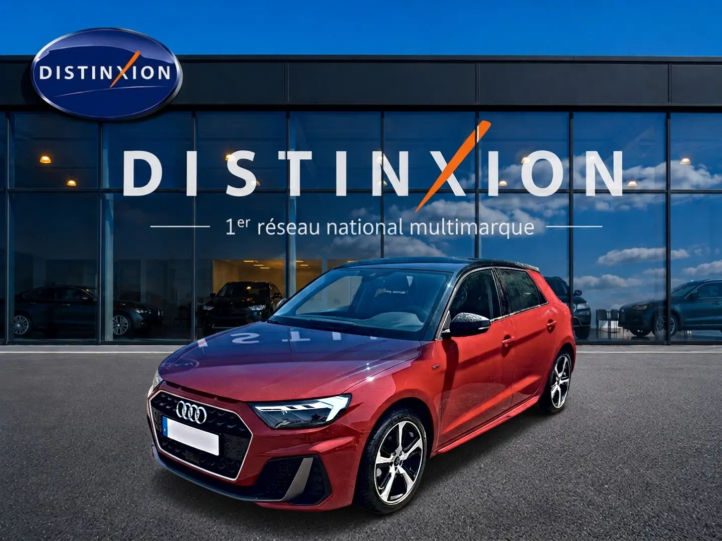 Audi A1 Sportback rouge et noir vue 3/4 avant droit devant un showroom Distinxion.