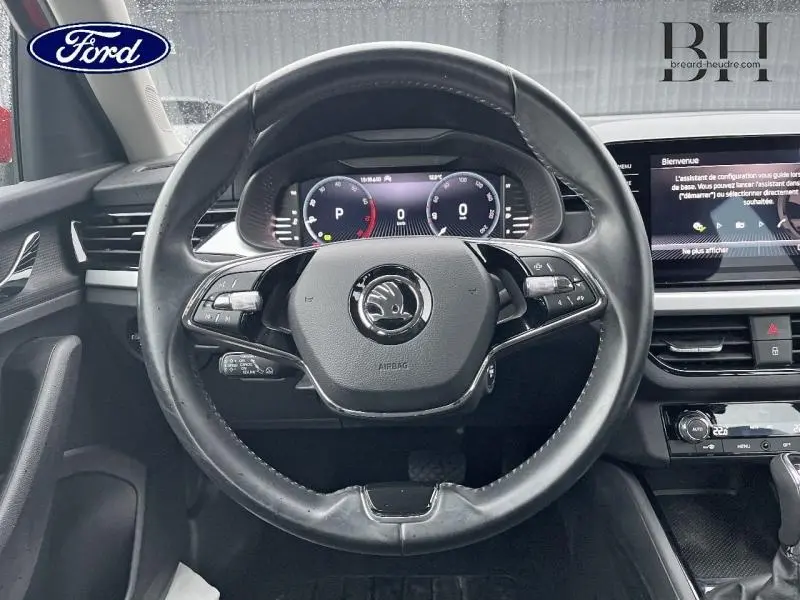 Vue frontale du volant cuir noir du Skoda Kamiq 2022 avec tableau de bord numérique et écran tactile central.