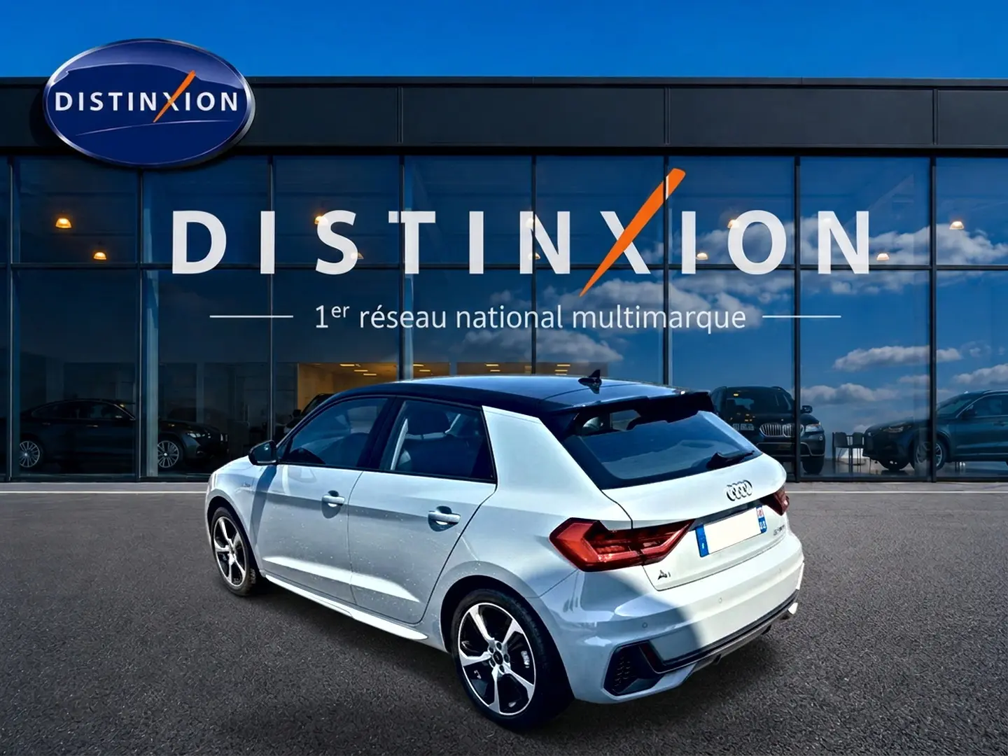 Audi A1 Sportback gris arrow avec toit noir, vue 3/4 arrière droit devant showroom Distinxion.