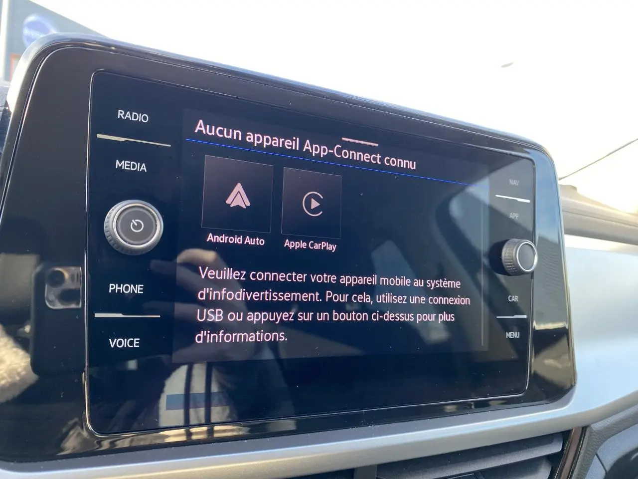 Écran tactile du système d'infodivertissement App-Connect dans un Volkswagen T-Roc noir, vue intérieure rapprochée.
