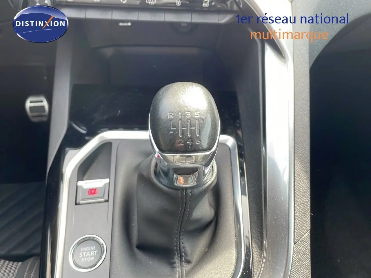 Le levier de vitesses manuel en cuir noir du Peugeot 3008 gris platinium, vue rapprochée de la console centrale.