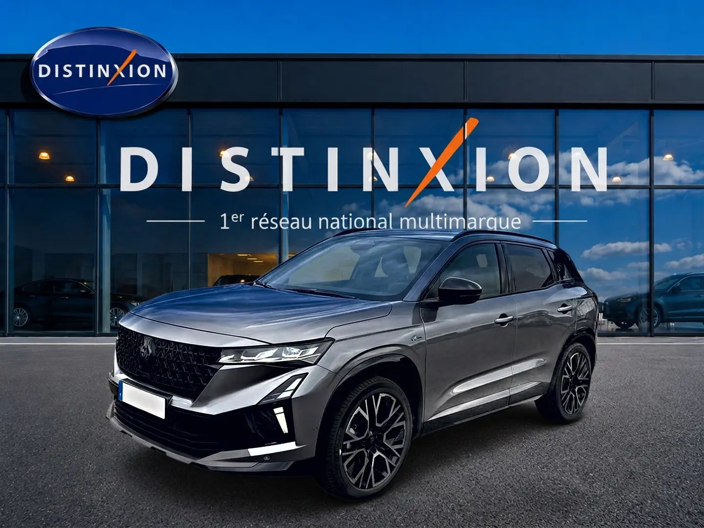 Renault Austral gris schiste en 3/4 avant droit, avec jantes alu noires et calandre noire distinctive.