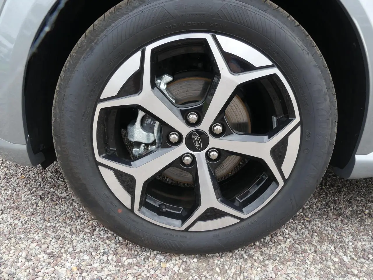 Gros plan sur la jante alliage 17 pouces bicolore du Ford Puma gris métallisé, avec logo Ford au centre.