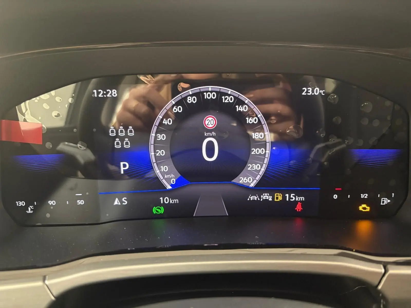 Affichage numérique du tableau de bord du Volkswagen Touran 2025, montrant la vitesse à 0 km/h et plusieurs voyants allumés.