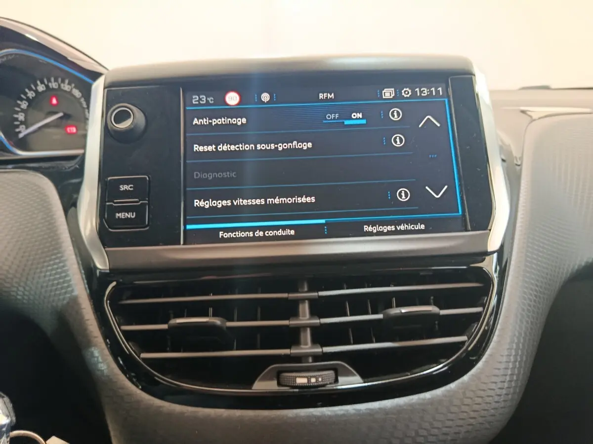 Écran tactile central affichant les réglages de conduite sur le tableau de bord d'un Peugeot 2008 gris foncé.
