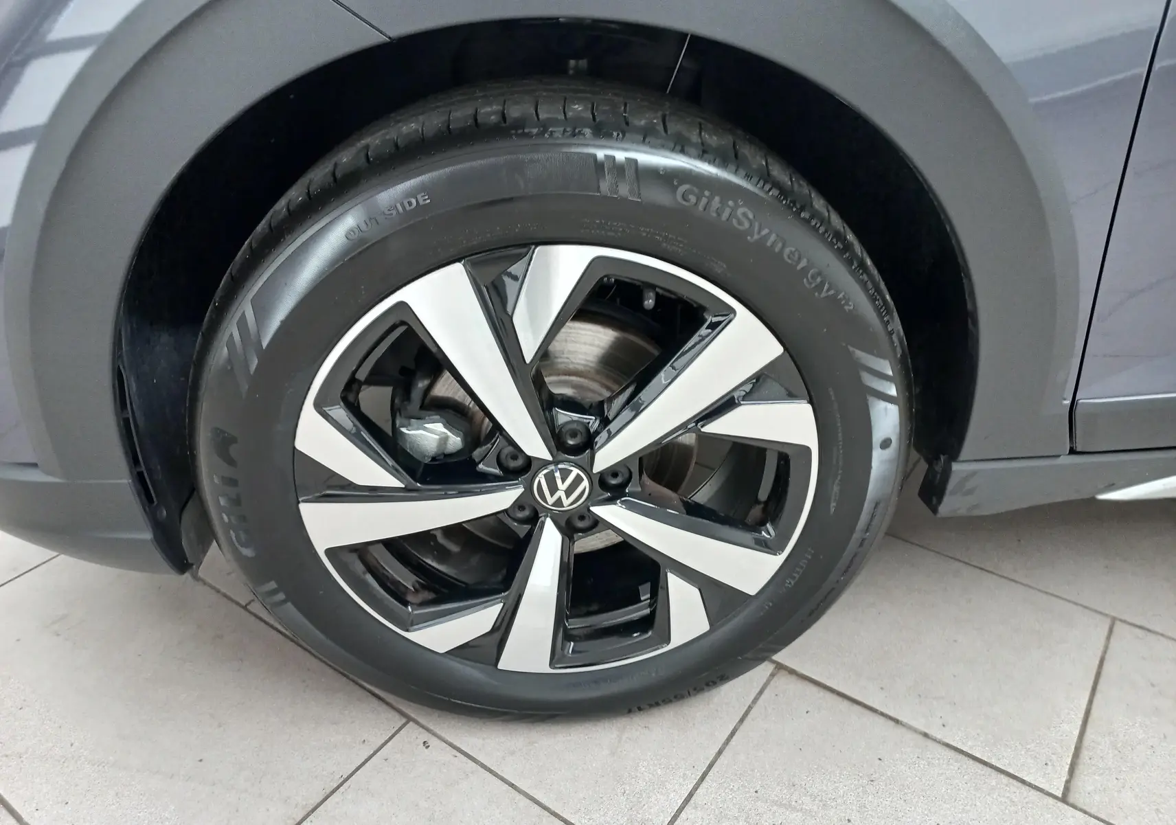 Gros plan sur la jante alliage 17 pouces Aberdeen et pneu GitiSynergy du côté avant droit du Volkswagen Taigo gris cendré.