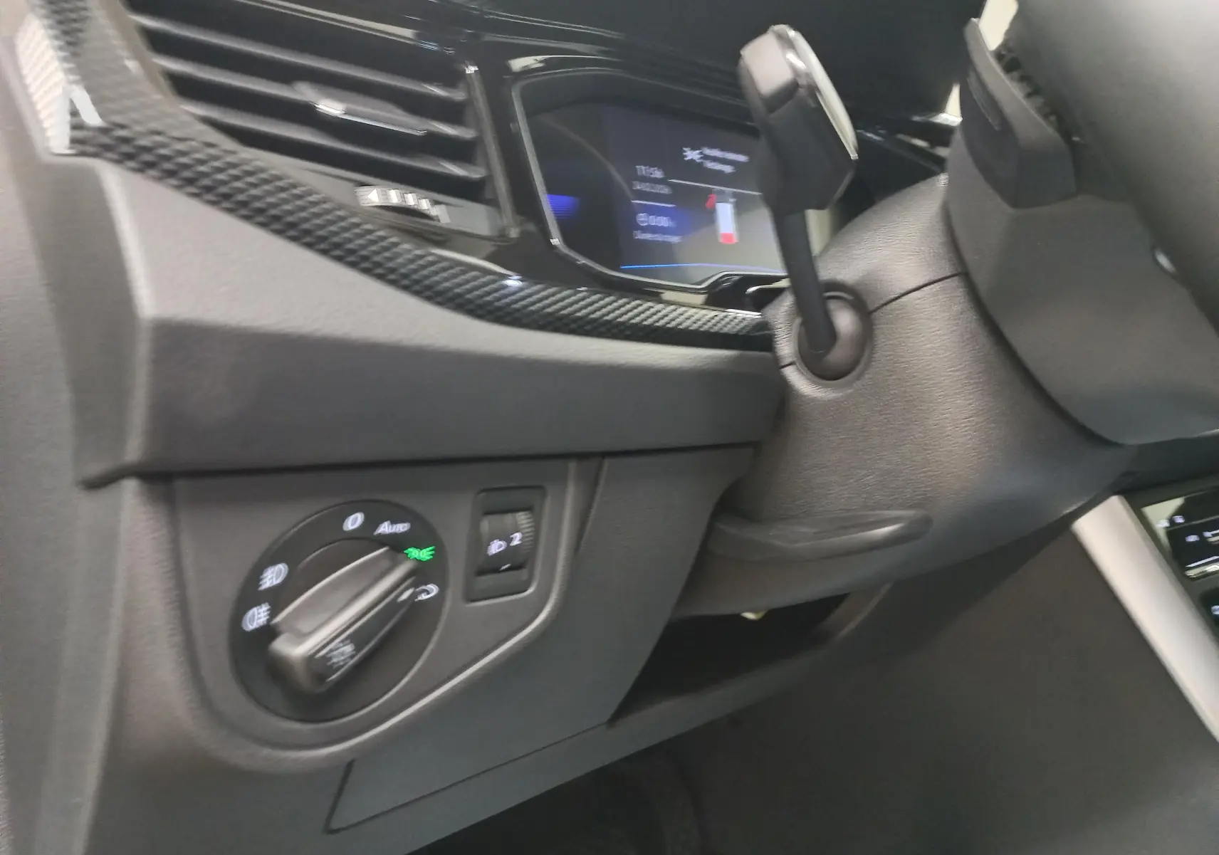 Détail intérieur du tableau de bord côté gauche du Volkswagen Taigo 2025 avec commandes d’éclairage et finition noire.
