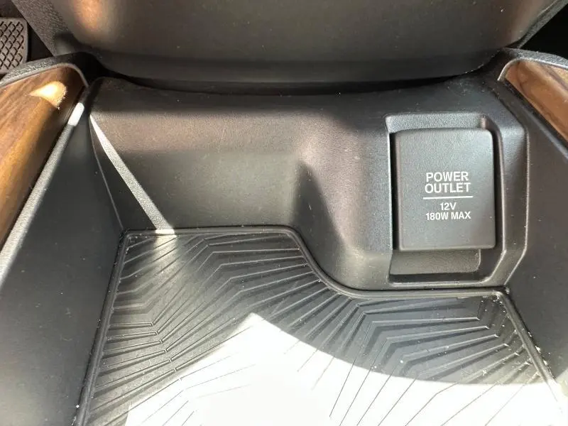Gros plan sur la prise 12V et le rangement central noir avec inserts bois du Honda CR-V Rouge Rallye 2020.