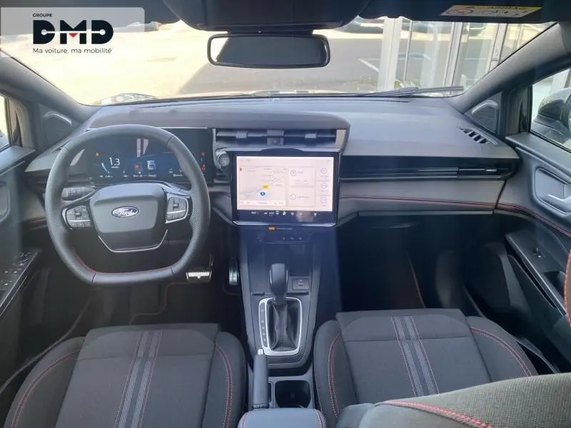 Vue intérieure avant du Ford Puma 2026 noir Agate, tableau de bord moderne avec écran tactile central et volant multifonction.