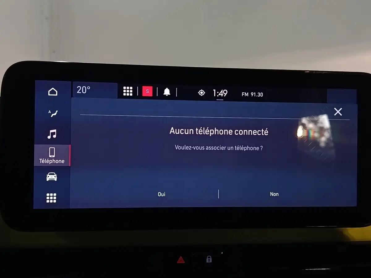 Écran tactile central affichant le menu téléphone du Fiat 500 BEV 24 kWh, intérieur moderne avec tableau de bord noir.