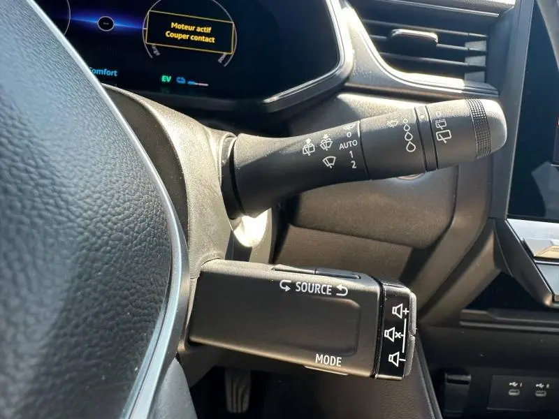 Gros plan sur les commandes au volant du Renault Captur 2025, avec leviers de clignotants et commandes audio visibles.