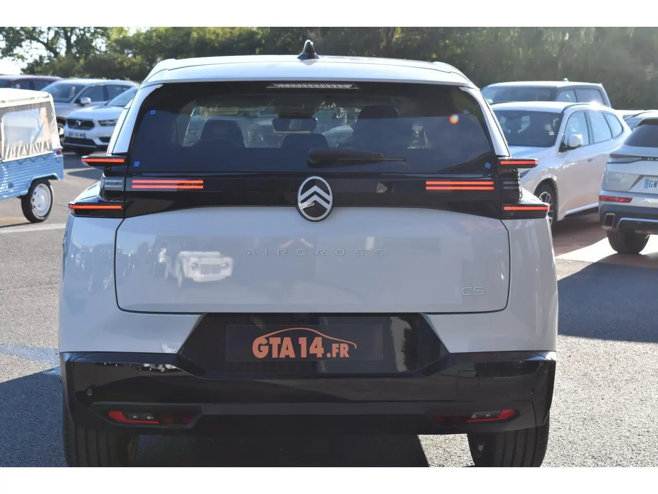 Vue arrière d'un Citroën C5 Aircross blanc avec feux LED horizontaux et hayon noir brillant.