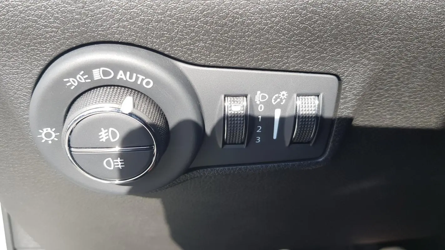 Gros plan sur la molette de réglage des phares et des feux antibrouillard du Jeep Compass blanc 2024.