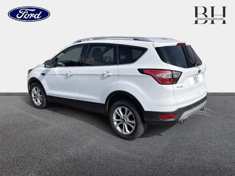 Vue 3/4 arrière droite du Ford Kuga blanc glacier avec barres de toit aluminium et hayon motorisé