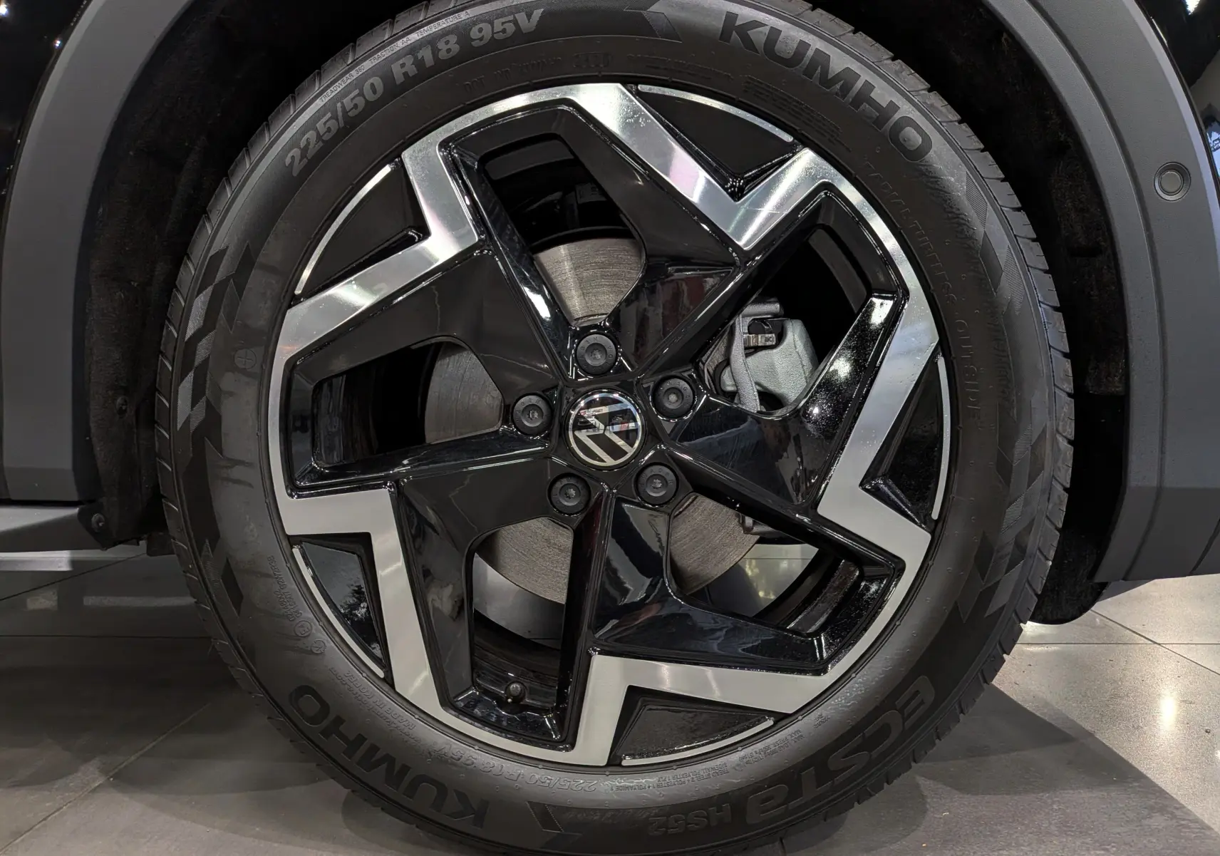 Gros plan sur la jante bi-ton noire et argent du Volkswagen T-Roc eTSI 150 CH DSG7 R-LINE 2026 en noir Ébène.