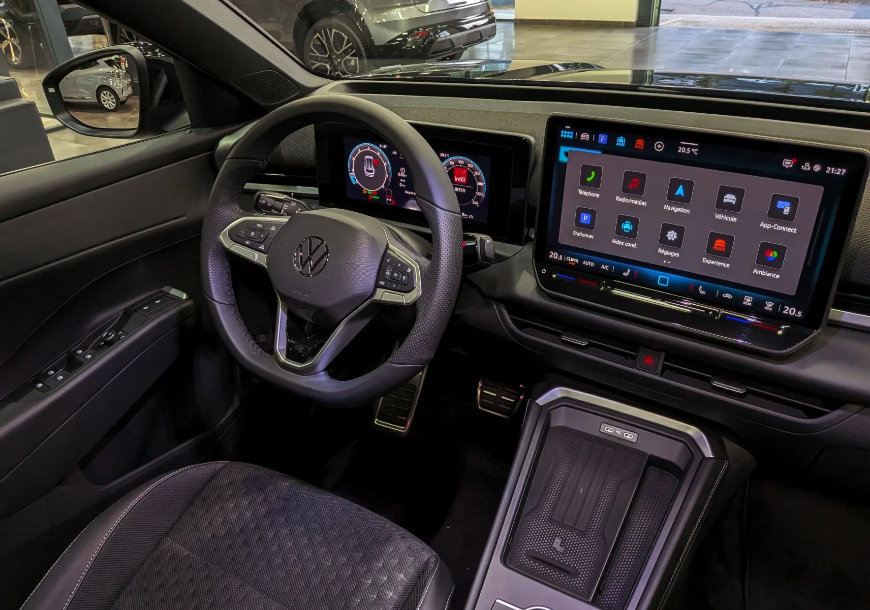 Vue intérieure côté conducteur du Volkswagen T-Roc eTSI 150 R-Line 2026 noir, avec tableau de bord digital et écran tactile central.