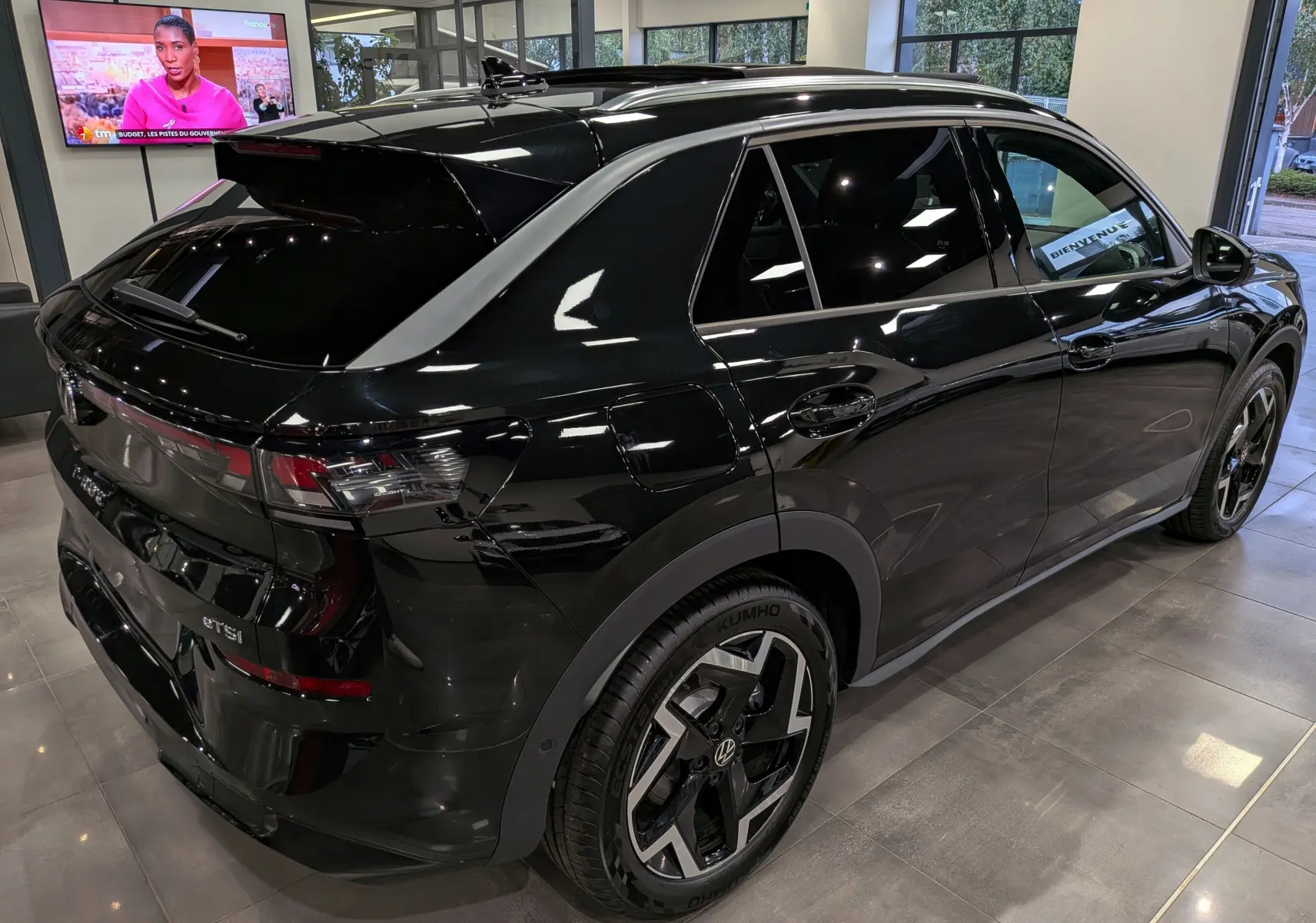 Vue 3/4 arrière droite du Volkswagen T-Roc eTSI 150 CH DSG7 R-Line noir Ébène avec jantes bi-ton et vitres teintées.