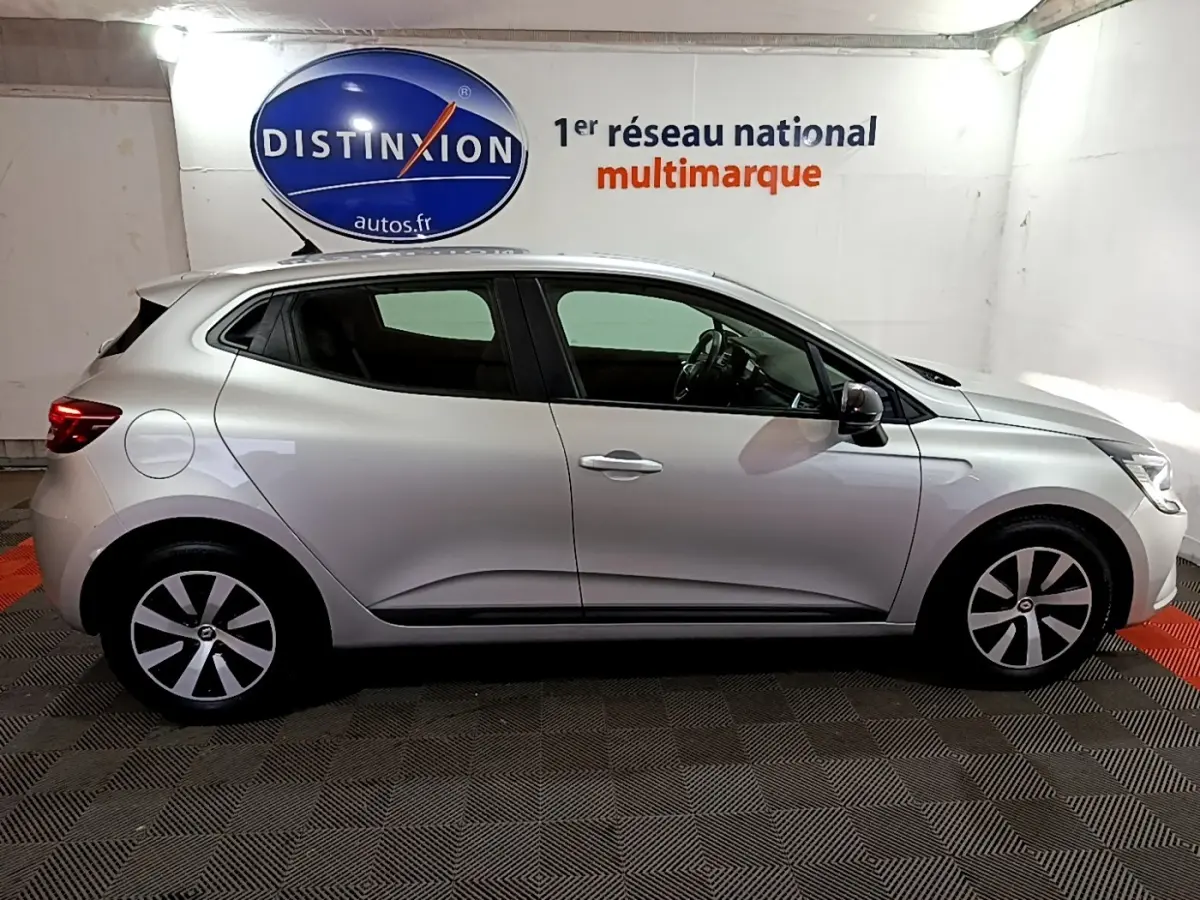 Profil droit d'une Renault Clio Equilibre TCe 90 gris clair 2023, avec jantes alliage et feux arrière LED visibles.