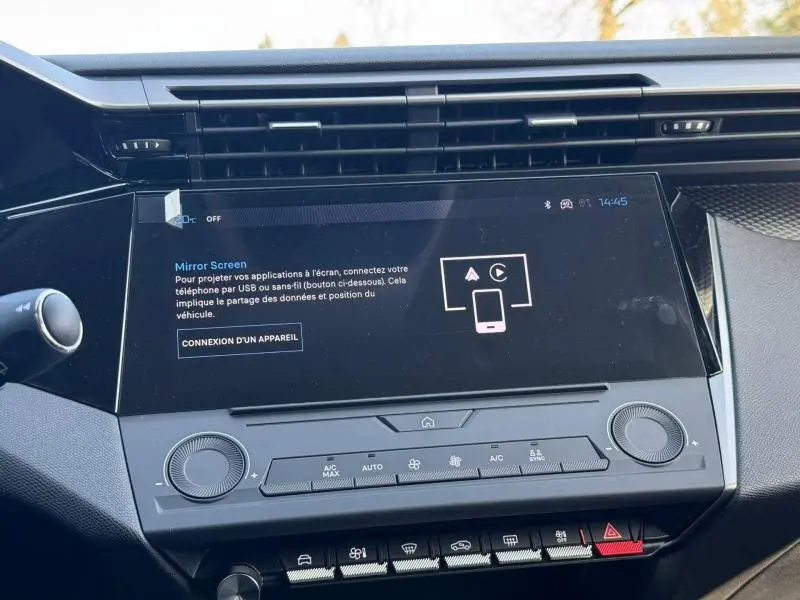 Vue rapprochée de l’écran tactile central et des commandes de climatisation de la Peugeot 308 blanche Okénite.