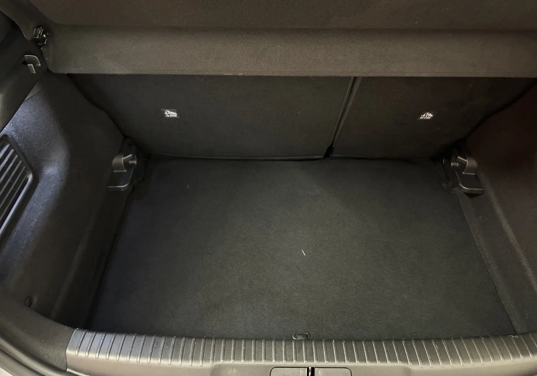 Coffre vide de l’Opel Mokka GS Line gris, vue plongeante montrant l’espace de rangement intérieur.
