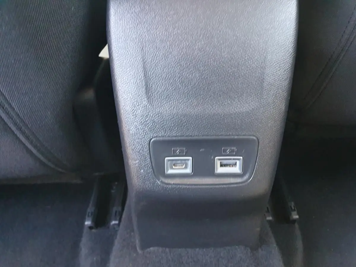 Prise USB type C et USB standard sur la console centrale arrière d'une Peugeot 208 hybride gris Sellenium.