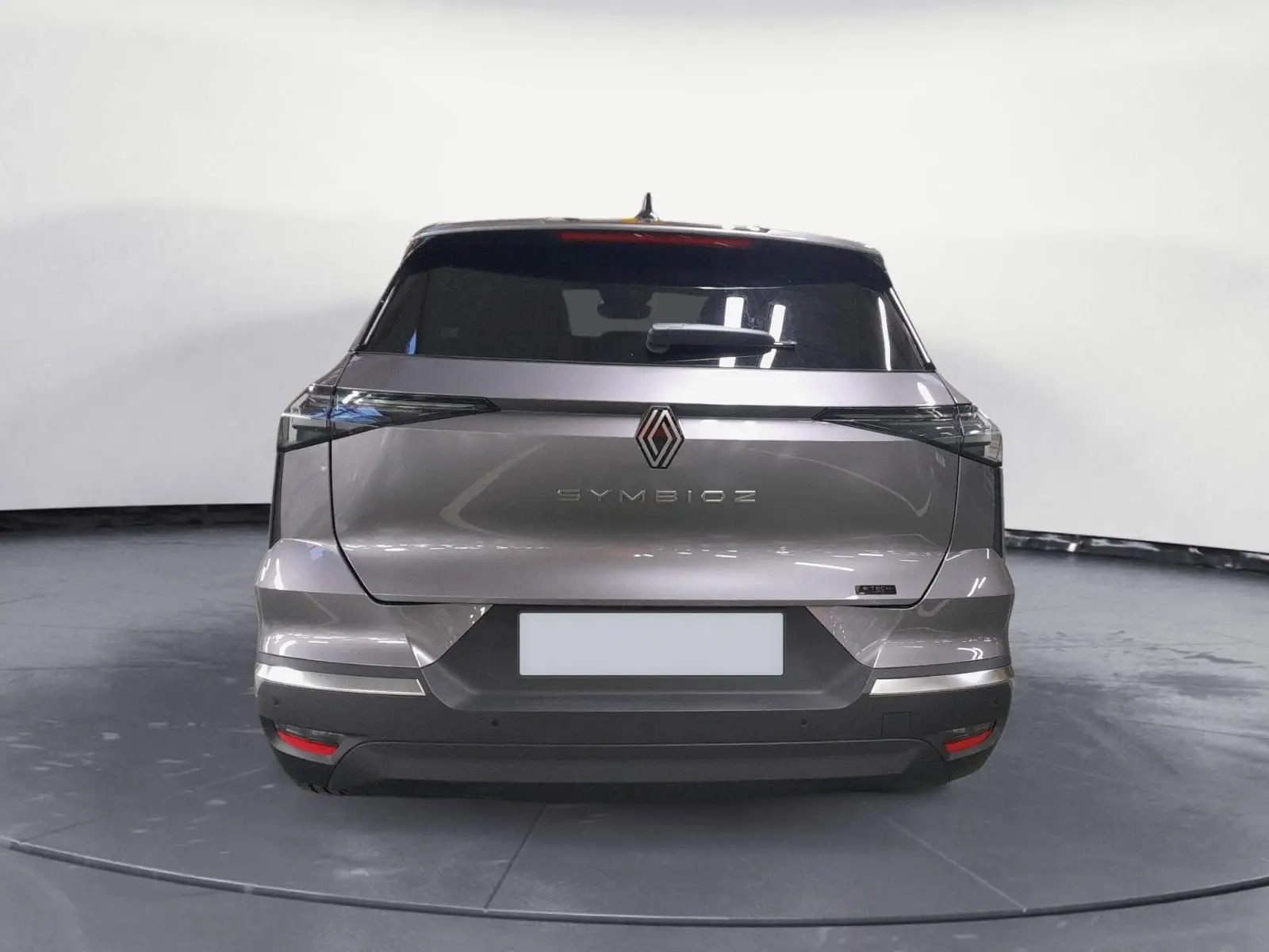 Vue arrière d'un Renault Symbioz gris Casiopee avec feux arrière fins et lunette arrière surteintée.