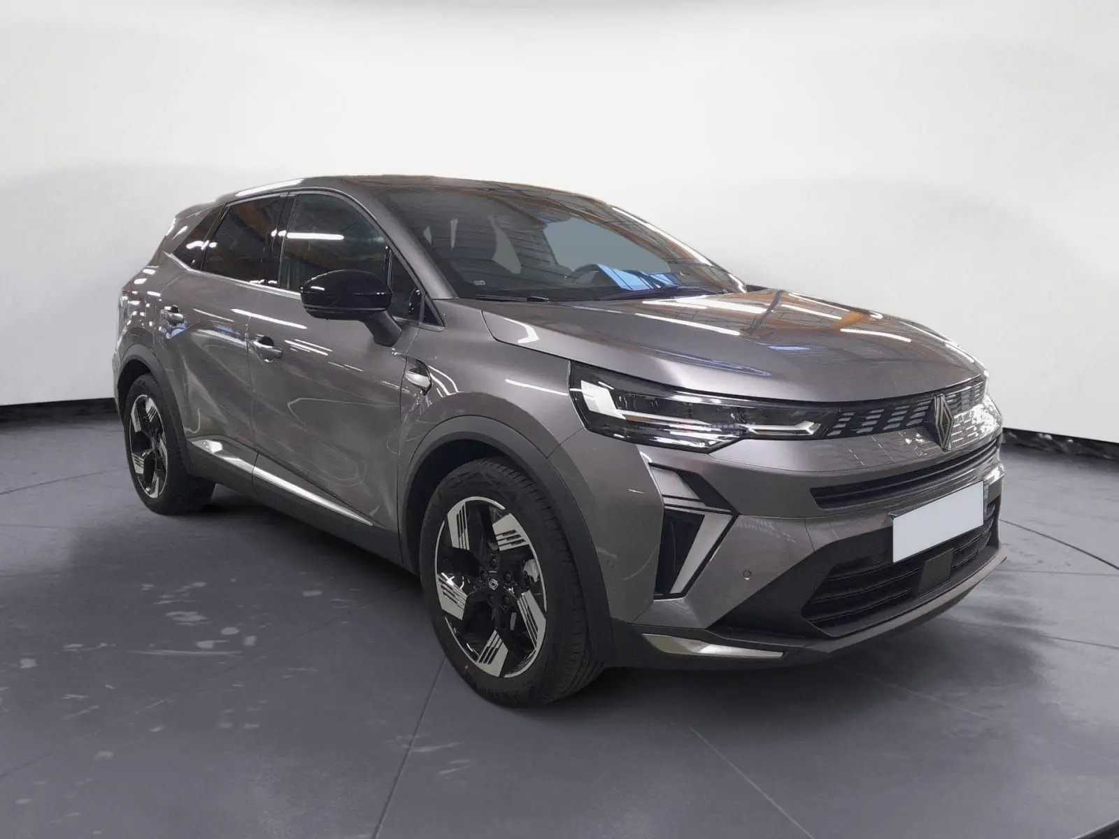 Renault Symbioz gris Casiopee en 3/4 avant droit, avec jantes alliage noires et phares LED distinctifs.