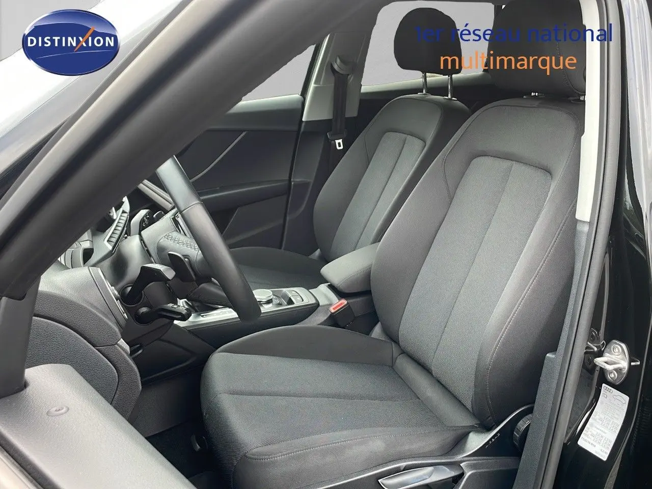 Intérieur avant droit d'Audi Q2 noir mito metal 2023, sièges tissu noir gris et console centrale visible