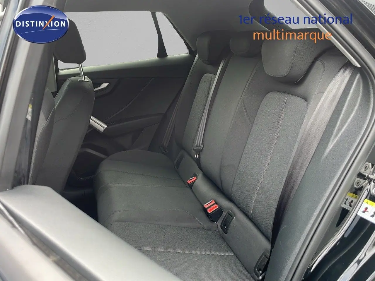 Vue intérieure côté droit montrant les sièges arrière en tissu noir d'un Audi Q2 35 TFSI S-Line 2023 noir mito metal.