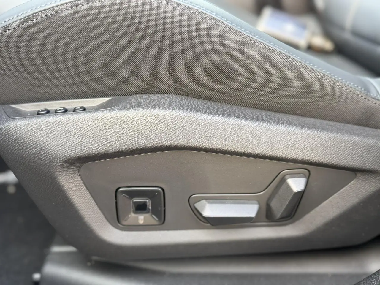 Détail des commandes de réglage électrique du siège conducteur en tissu bleu sur Citroën C5 Aircross 2026.