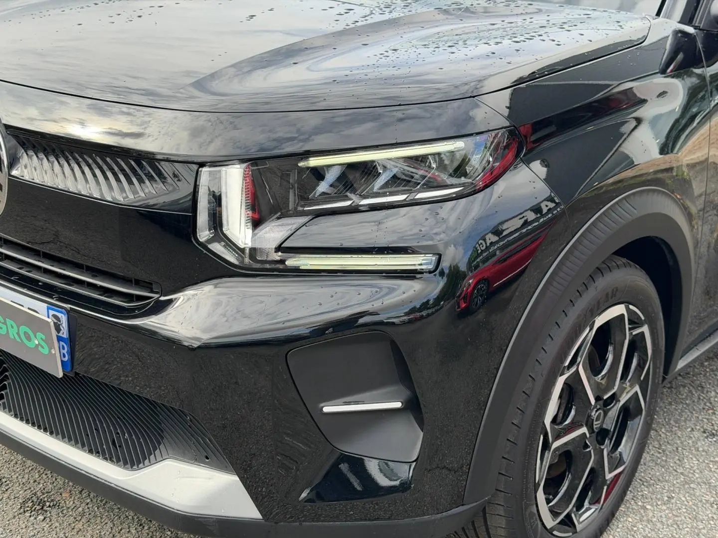Gros plan sur l'avant droit de la Citroën C3 2025 noire, mettant en valeur ses phares LED et sa jante au design moderne.