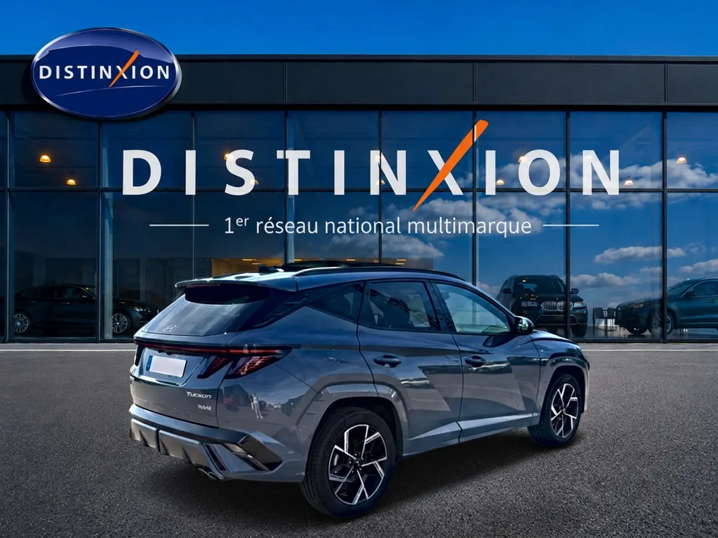 Hyundai Tucson 1.6 t-gdi 239 hybride N Line gris shadow, vue 3/4 arrière droit devant showroom Distinxion.