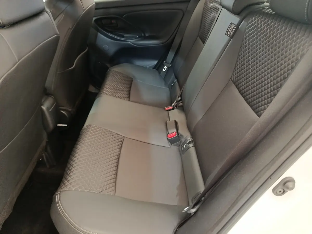 Vue intérieure arrière côté droit des sièges noirs en tissu avec motifs géométriques de la Toyota Yaris Hybride 2022.