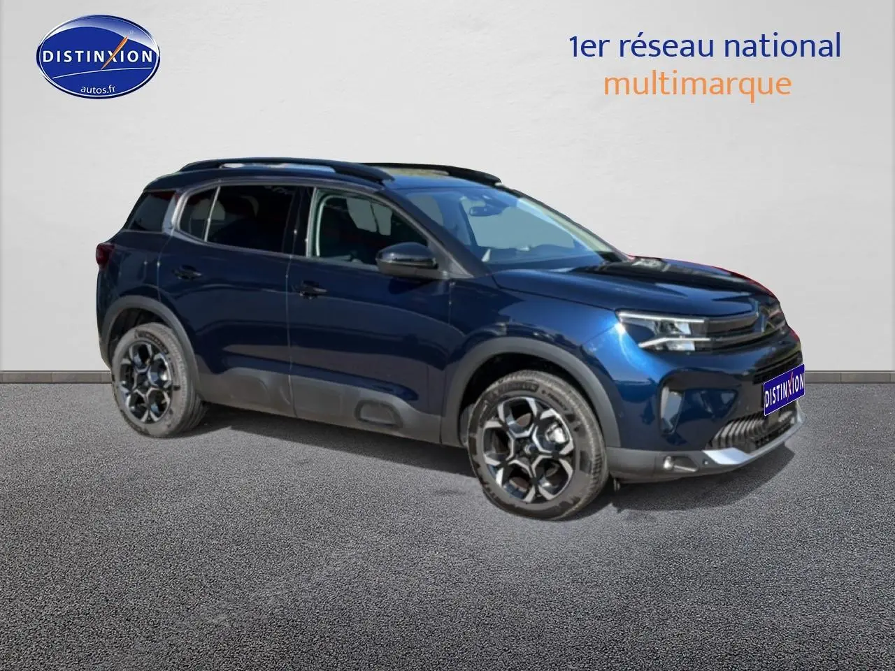Citroën C5 Aircross bleu eclipse vue 3/4 avant droit avec jantes alu et barres de toit visibles.