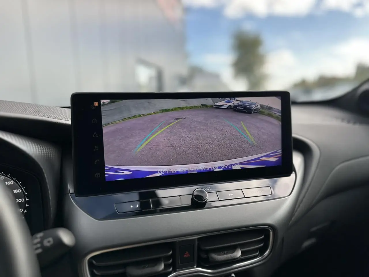 Écran tactile intérieur du Nissan Juke 2025 montrant la caméra de recul avec guidage dynamique.