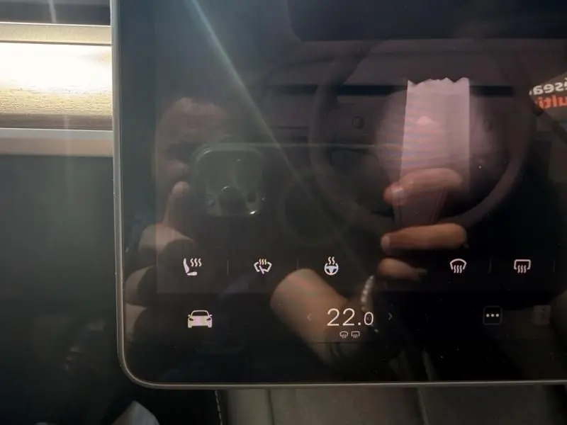 Écran tactile intérieur du Tesla Model 3 noir 2022, affichant les commandes de chauffage et climatisation.