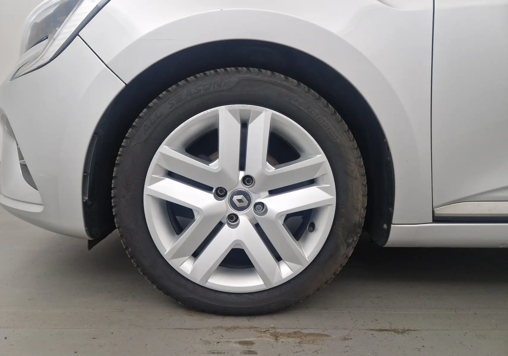 Gros plan sur la roue avant gauche gris platine d'une Renault Clio V 1.0 TCE 90 Zen avec jante alliage distinctive.