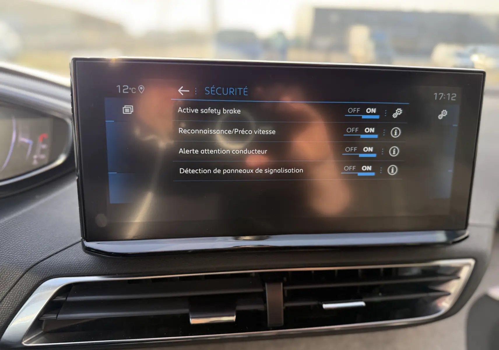 Écran central du tableau de bord du Peugeot 3008 gris, affichant les options de sécurité activées.