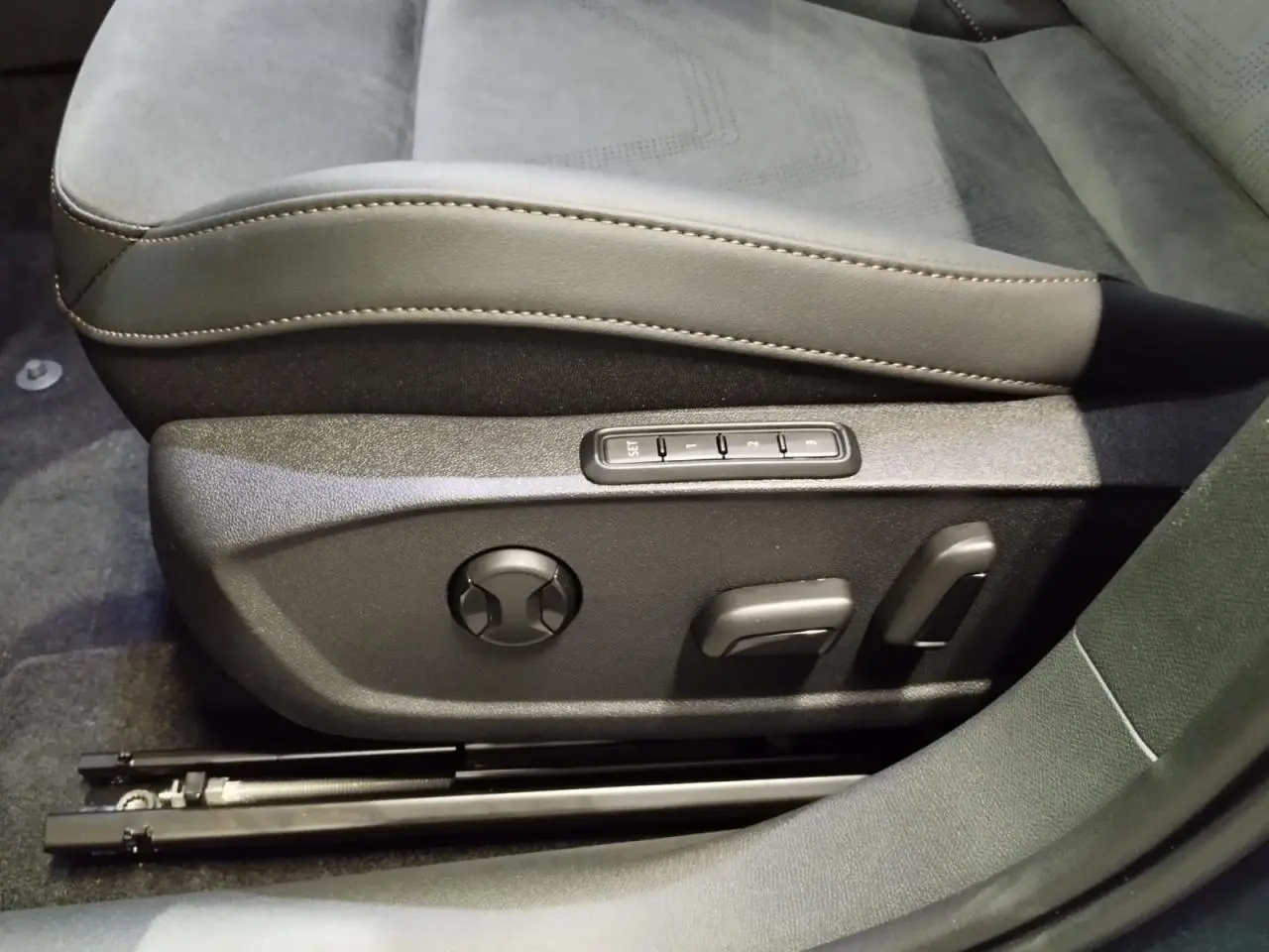 Gros plan sur les commandes électriques du siège conducteur en suédine noire et cuir beige du CUPRA Formentor 2026.