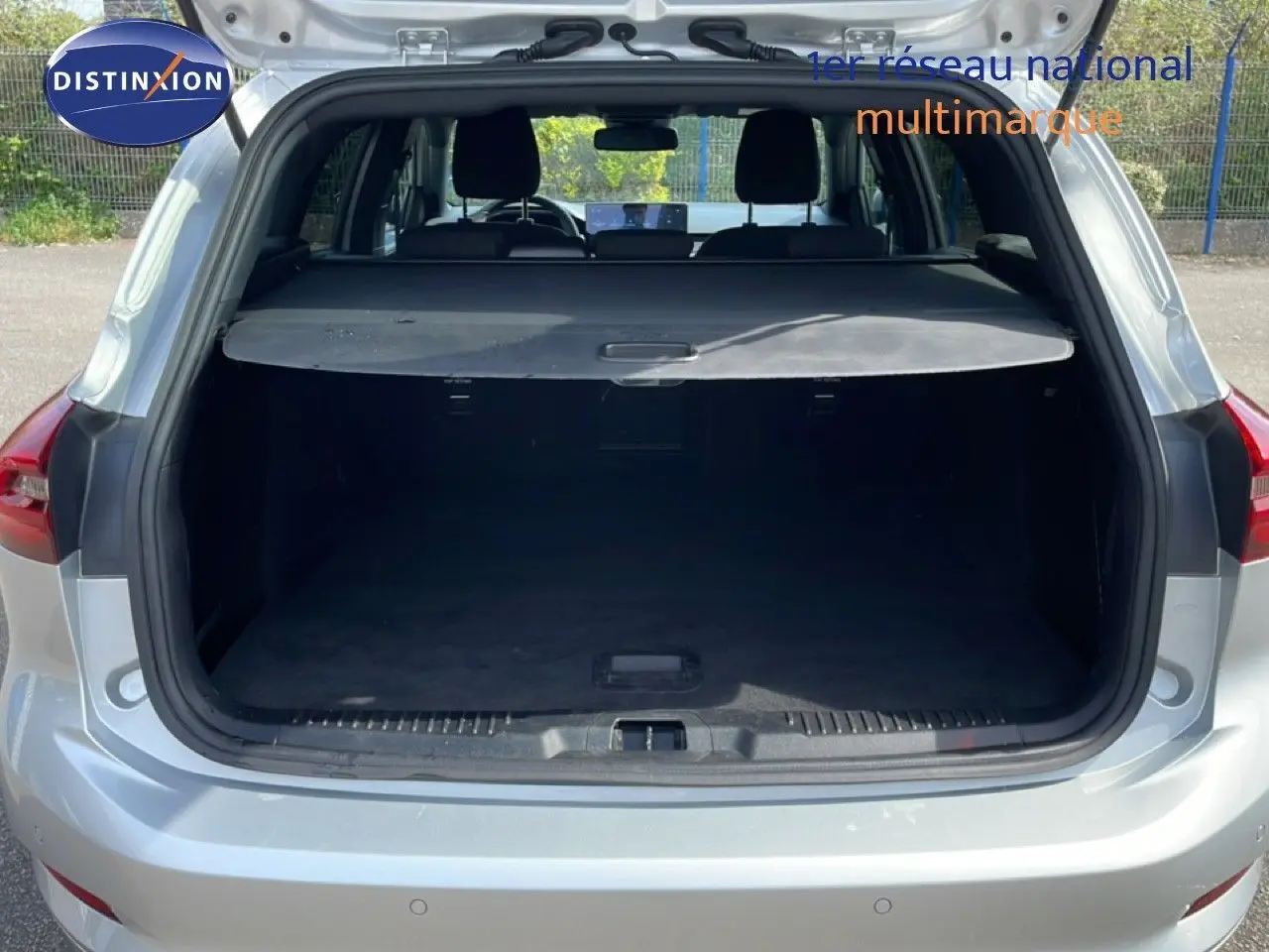 Coffre ouvert vu de l'arrière d'une Ford Focus SW 1.0 EcoBoost MHEV 125ch ST-Line X gris lunaire métal, intérieur noir.