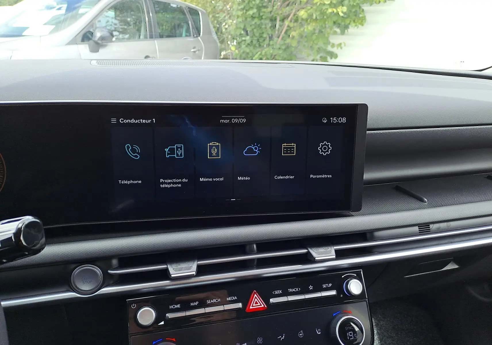 Tableau de bord du Hyundai Tucson IV Ph.2 STYLE 2025 en Ecotronic Grey, écran tactile et commandes climatisation visibles.