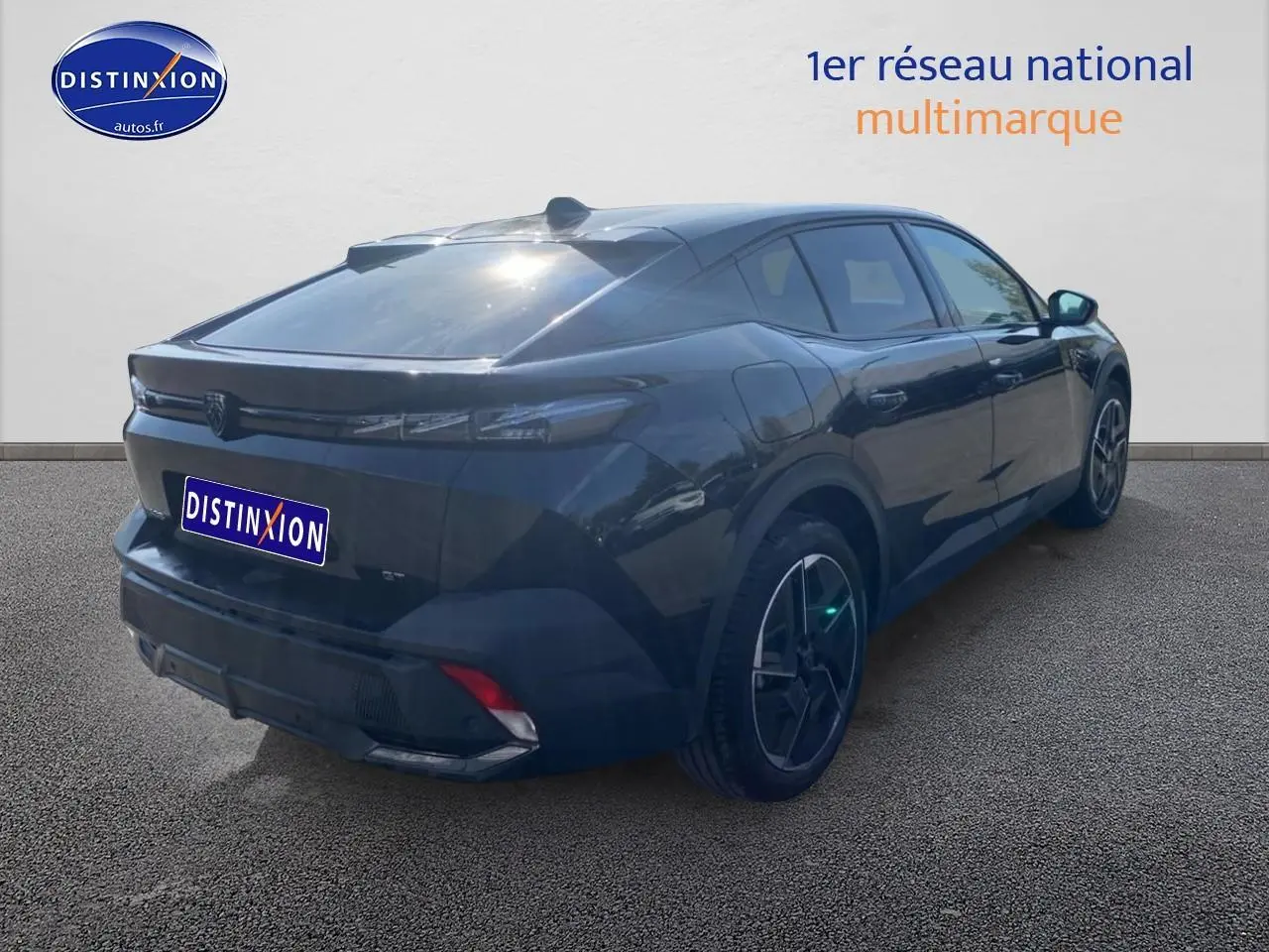Vue 3/4 arrière droite d'une Peugeot 408 Hybrid 145 GT noire avec jantes alu et feux arrière LED fins.